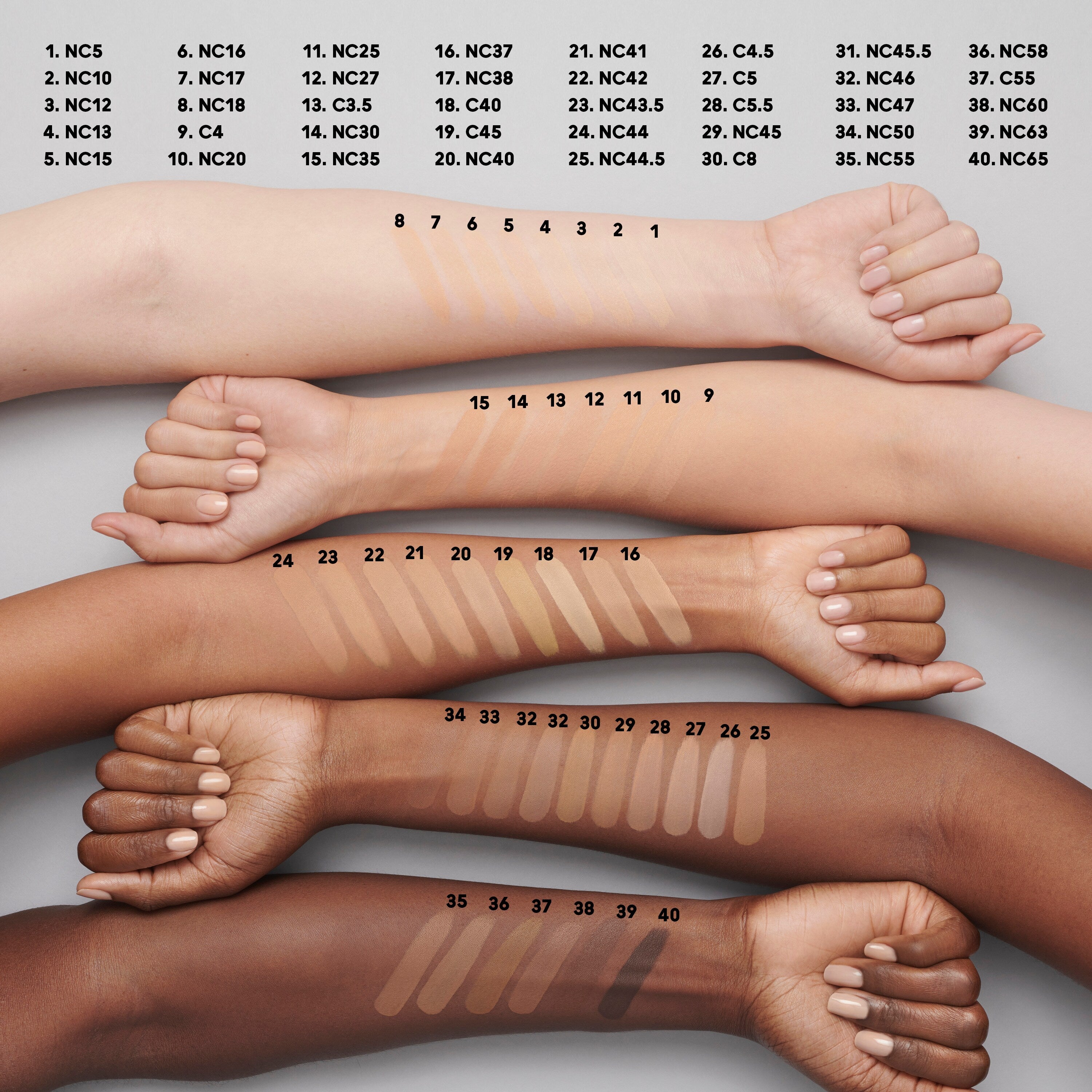 An image of lots of the colors for the Studio Fix Foundation. There are different coloured smudges of foundation on 5 different arms.